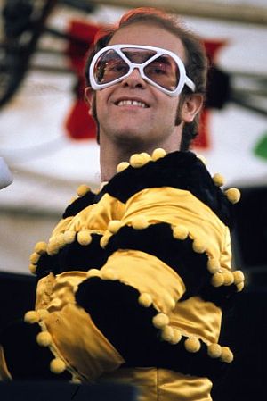 Elton-bee-and-big-white-glasses-put-mid-