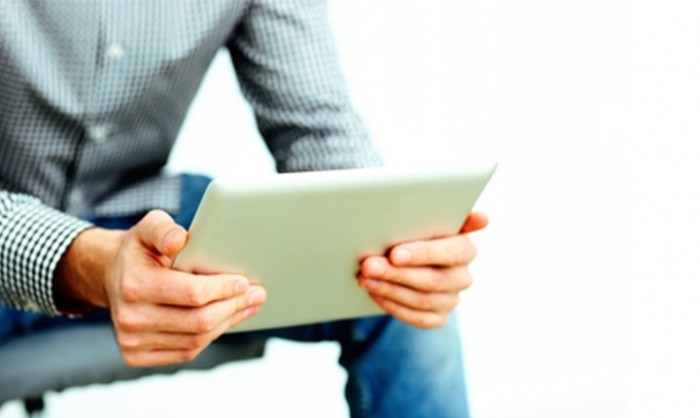Reading on a tablet.