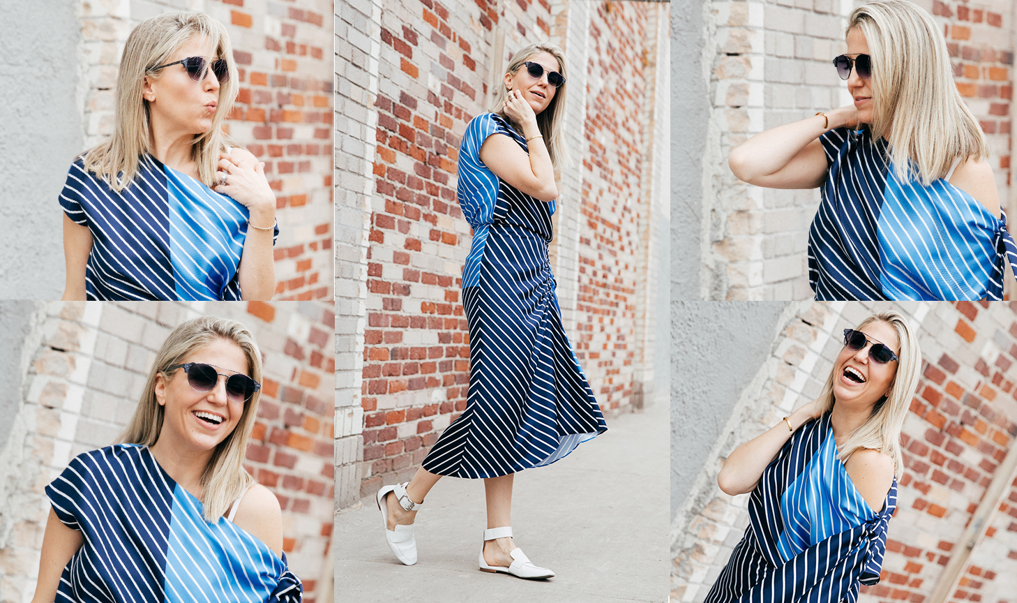 Woman wearing a striped blue and black dress with white shoes and sunglasses, posing against a brick wall.