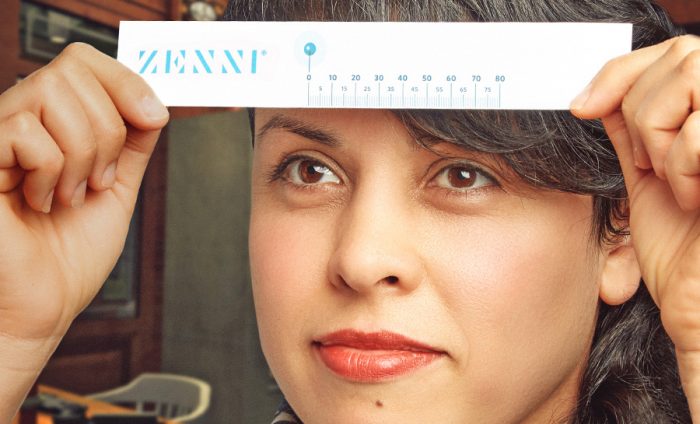 Woman using a PD ruler to measure her pupillary distance.
