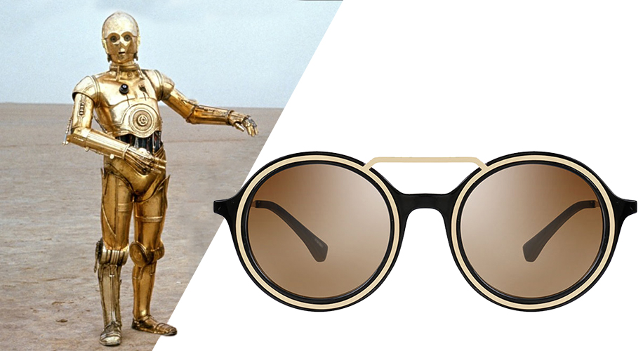 Retro round sunglasses with brown lenses and black frame, beside a gold-colored robot.