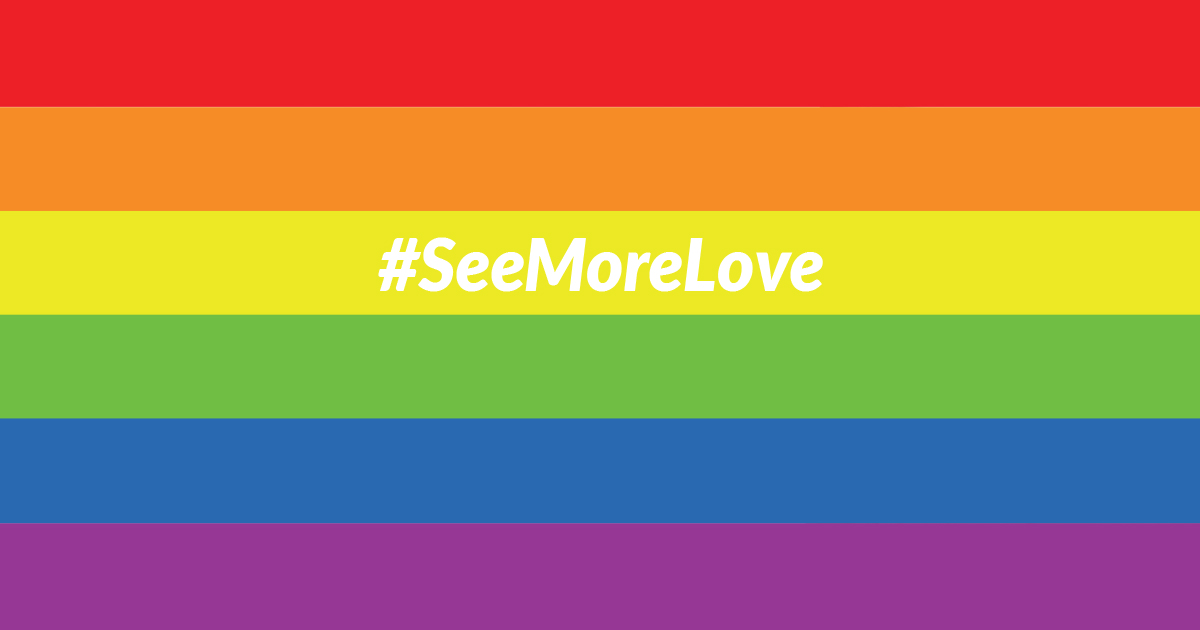 Rainbow flag with the text &quot;#SeeMoreLove&quot; written in white.