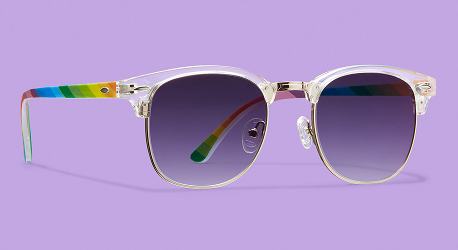 Sunglasses with rainbow-colored arms, transparent frame, and dark gradient lenses on a purple background.