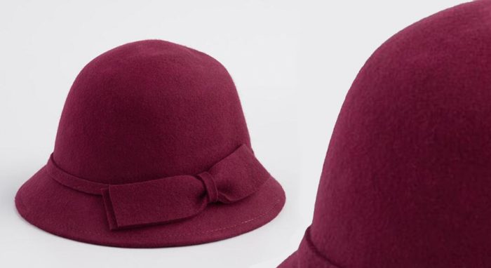 Maroon wool cloche hat with a bow band.