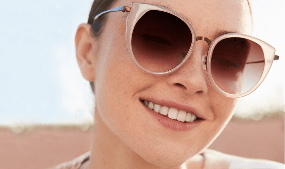 Image of a woman wearing sunglasses with UV protection.
