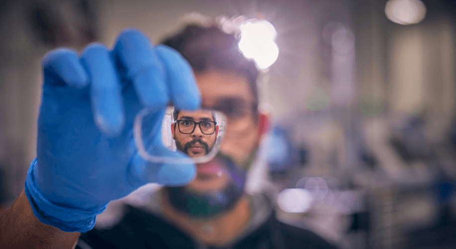 Man looking through a lens for eyeglasses. 