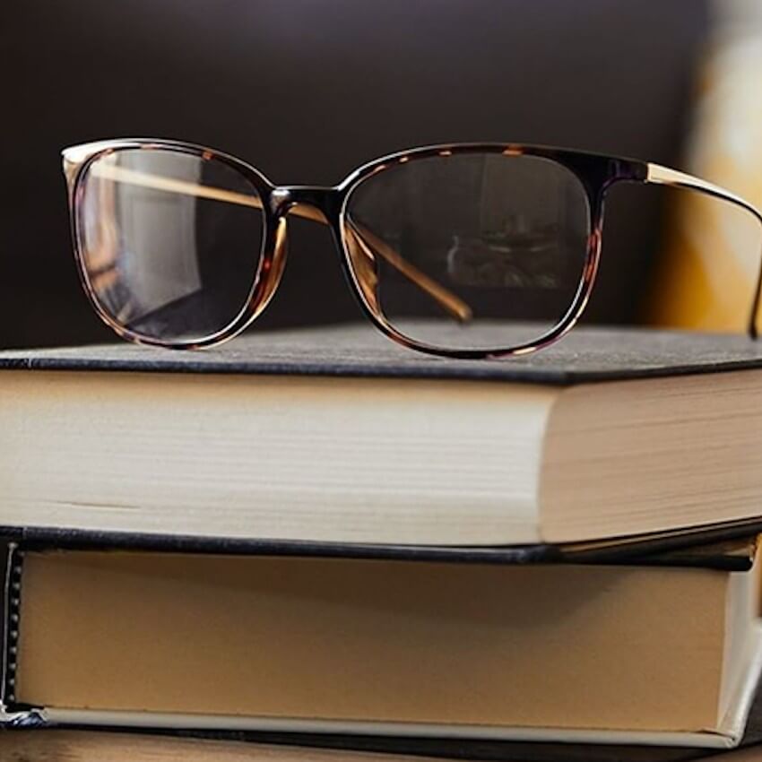 glasses on a set of books-featured
