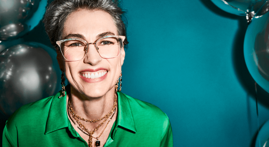 An older women wears a pair of horn-rimmed glasses.