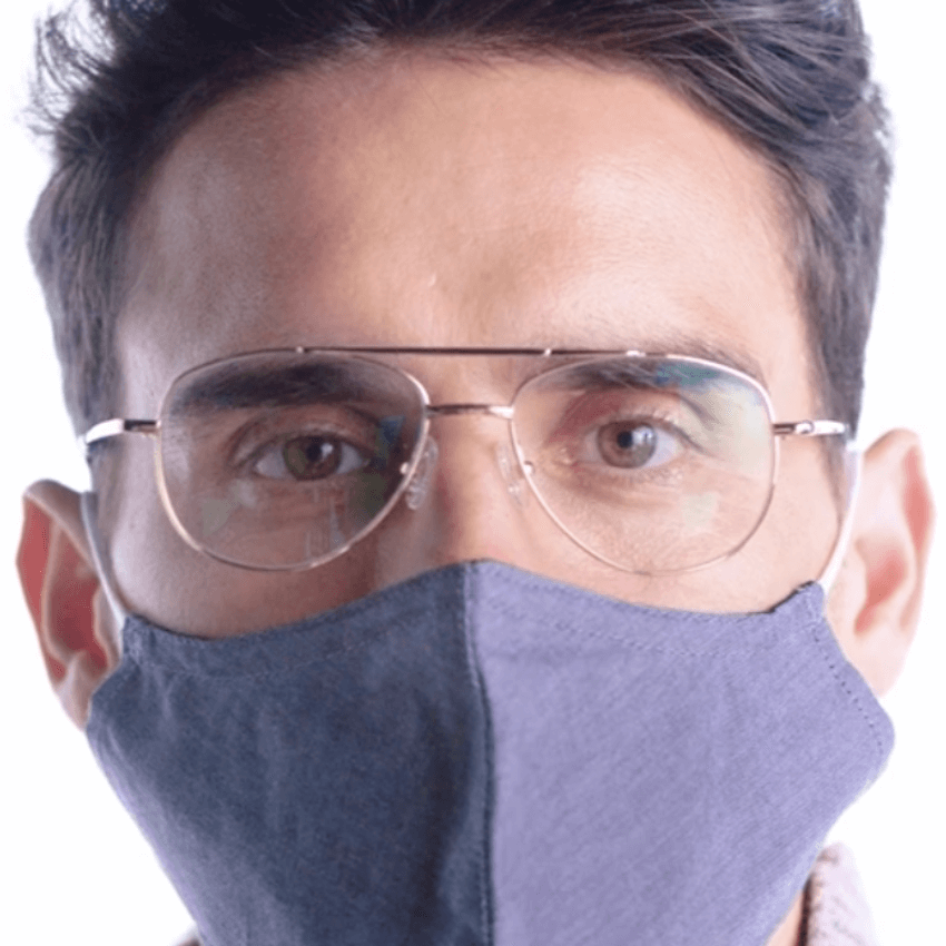 Man wearing glasses and a blue face mask.