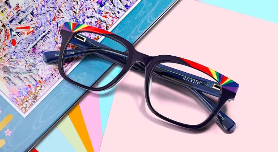 Black square eyeglasses with rainbow accents on the top corners. Text inside the frame: &quot;ZAZAZZ&quot;, &quot;Made in China&quot;.