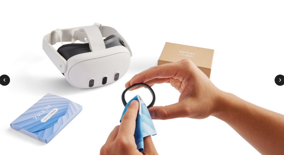 Hands cleaning a VR headset lens with a blue cloth. In the background, a VR headset, Zacro lens cover, INNZA box.