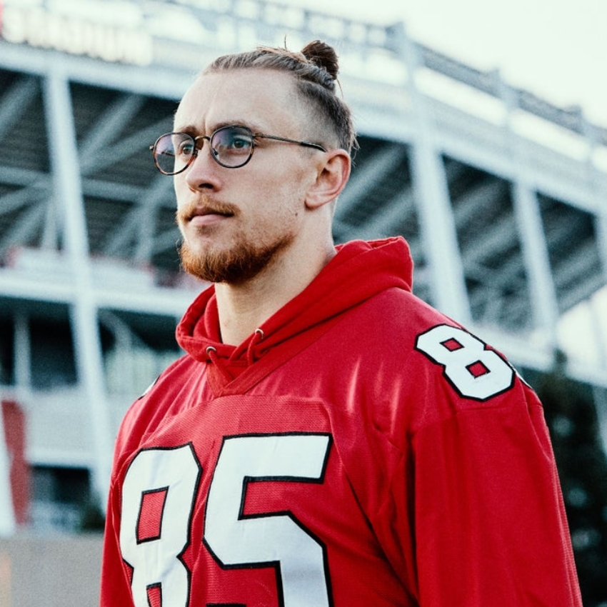 Man wearing a red sports jersey with the number 85.