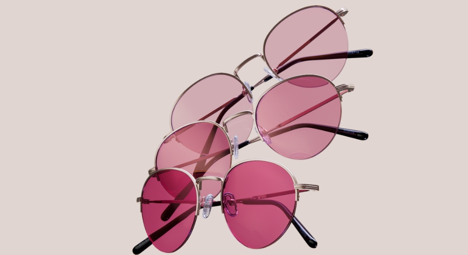 Three pairs of pink-tinted sunglasses with silver frames arranged in a cascading pattern.
