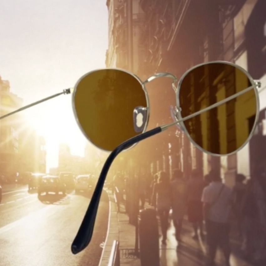 Close-up of aviator sunglasses with brown-tinted lenses and thin metallic frames.