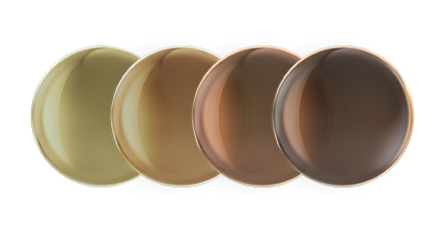 Contact lenses in four different brown shades arranged in a row.