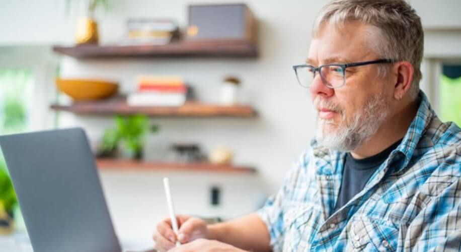 Man using a stylus with a laptop.