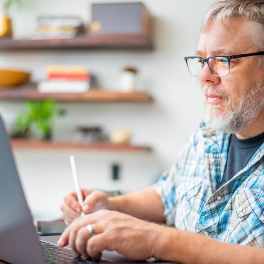 Man using a laptop and stylus pen.