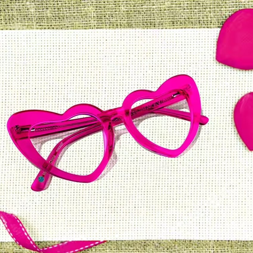 Bright pink, heart-shaped glasses with transparent lenses.