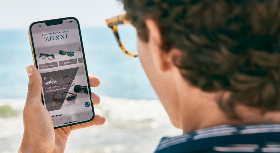 Phone screen showing a website for Zenni Eyewear with categories Eyeglasses and Sunglasses under Best Sellers.