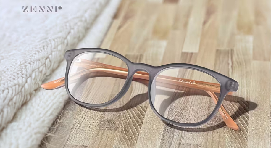 Zenni® gray eyeglasses with &quot;145 47 16&quot; and &quot;Zenni&quot; inscriptions on peach-colored arms.