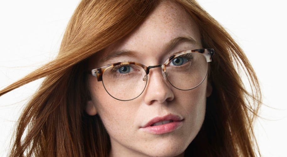 Person wearing tortoiseshell patterned round eyeglasses.