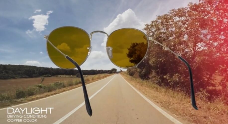 DAYLIGHT DRIVING CONDITIONS COPPER COLOR sunglasses. Sunglasses shown on an open road under a clear sky.