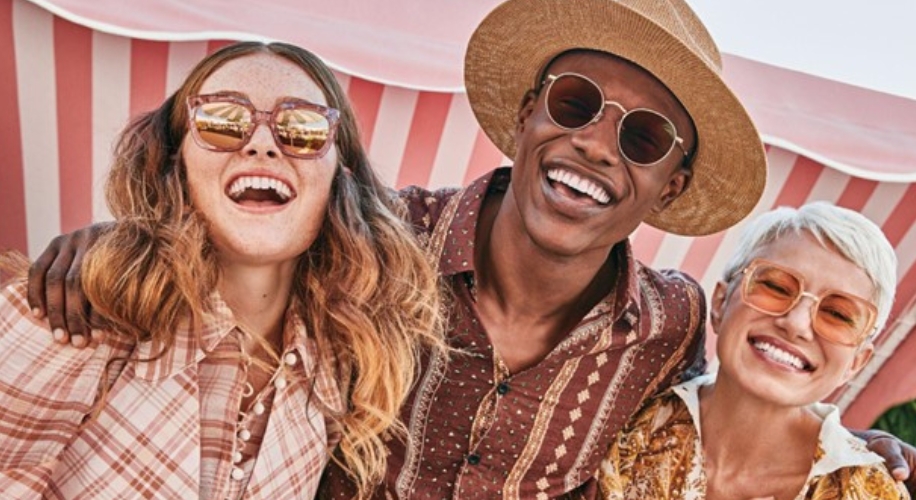 People wearing stylish sunglasses and summer clothing, smiling and enjoying a sunny day.