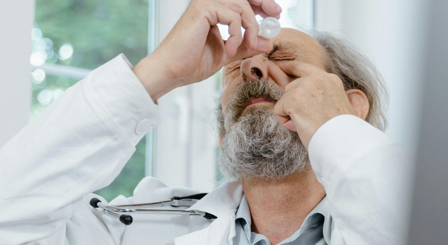 Man applying eye drops.