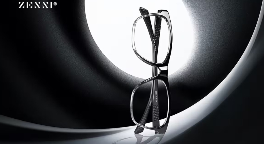 Zenni black and clear eyeglasses with &quot;Zenni&quot; logo on the side against a modern black and white background.