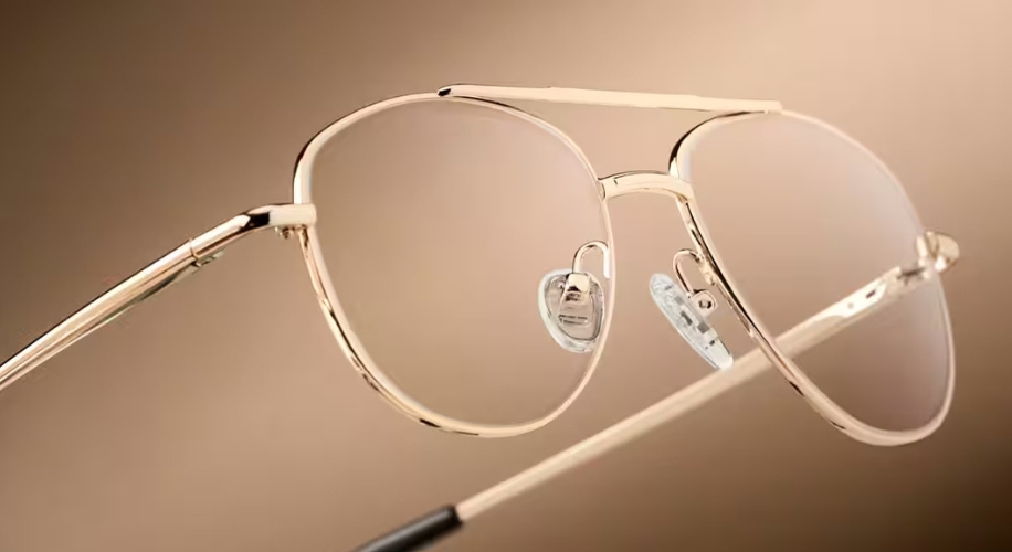 Gold-rimmed aviator eyeglasses with clear nose pads and a thin bridge.