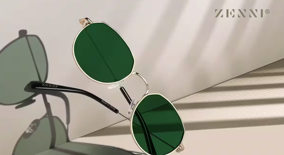 Zenni sunglasses with green oval lenses, thin metallic frame, and black temple arms. Text: ZENNI