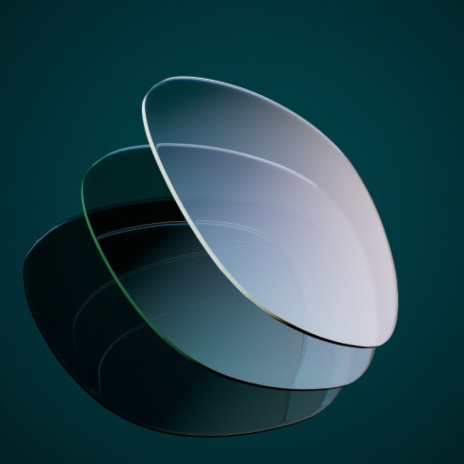 Concave glass lenses stacked together against a dark green background.