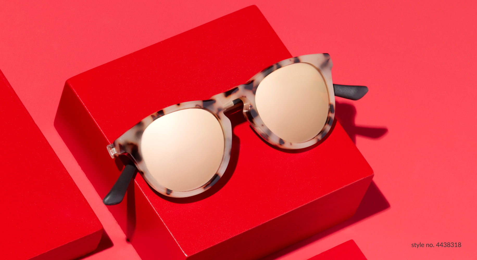Tortoiseshell sunglasses with gold lenses on red background. Text: &quot;style no. 4438318&quot;.