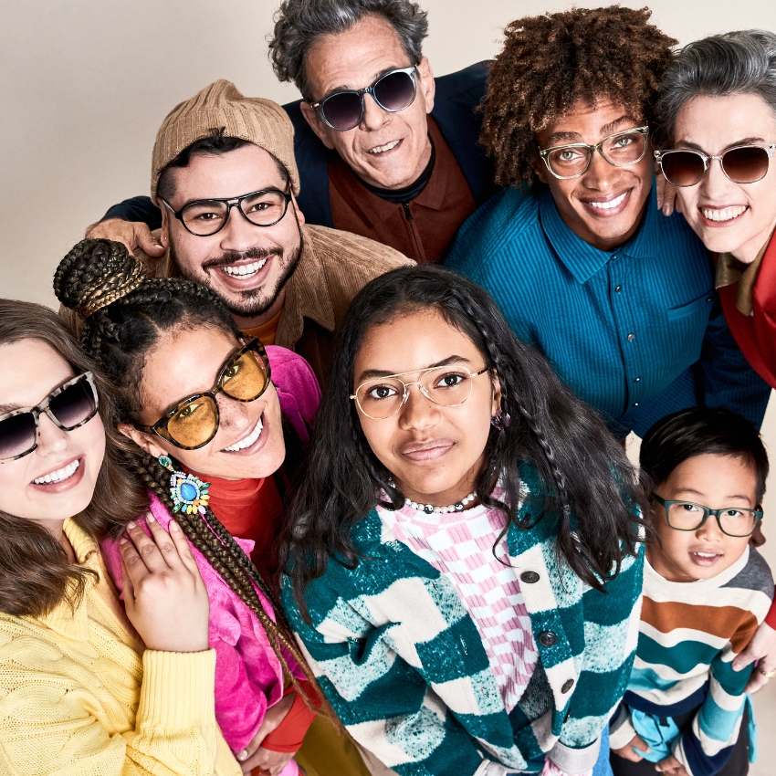 Group of people wearing various styles of eyeglasses, including sunglasses and optical frames.