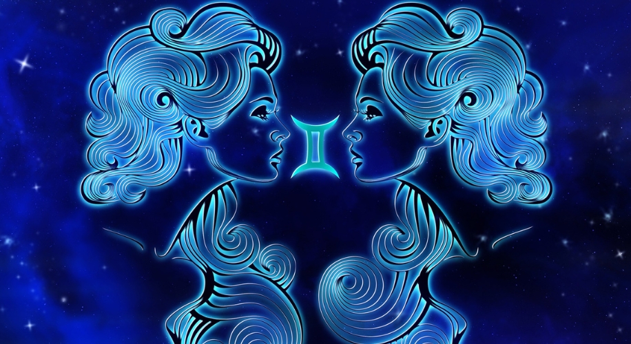 Gemini zodiac sign with two mirrored faces depicted in blue lines against a starry background.