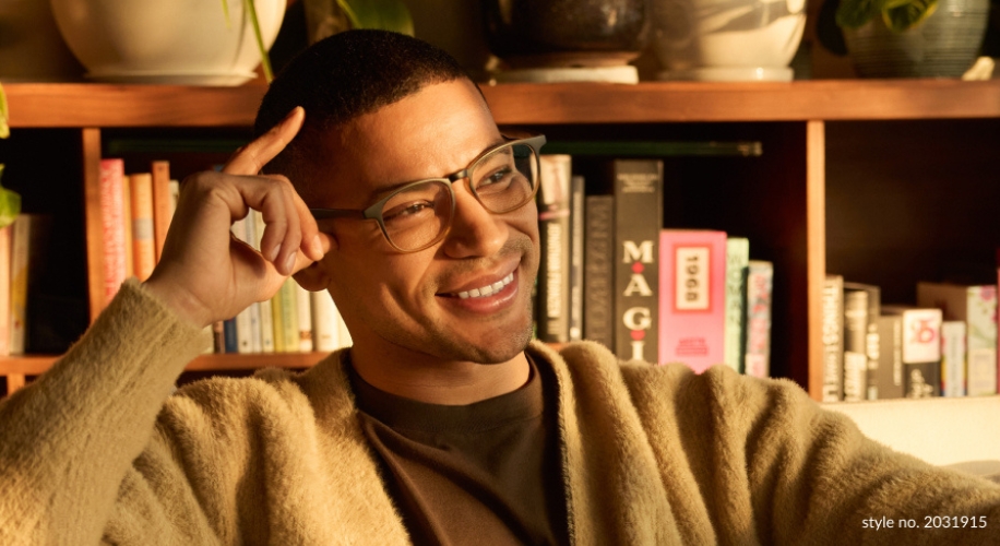 Man wearing stylish eyeglasses, style no. 2031915, sitting and smiling.