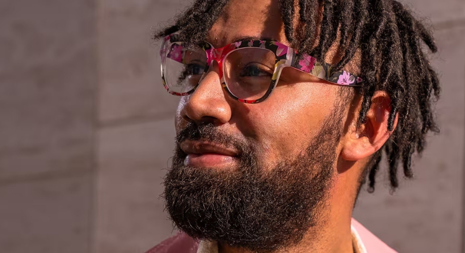 Man wearing glasses with vibrant floral-patterned frames.