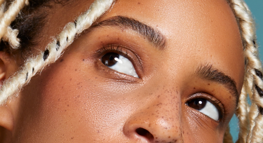 Close-up of a person&#039;s eyes and eyebrows with light-colored braided hair visible on the left side.