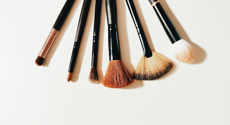 Set of six makeup brushes with black handles, including eyeshadow, blending, and face brushes.