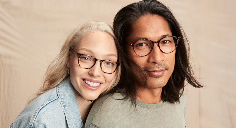 Two people wearing stylish eyeglasses, one with a round tortoiseshell frame and the other with a black rectangle frame.