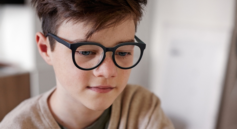 Boy wearing black-framed glasses.