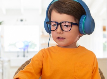 Image of a toddler wearing stereo headphones, wearing Zenni glasses, with the reflection of a screen on the lenses.
