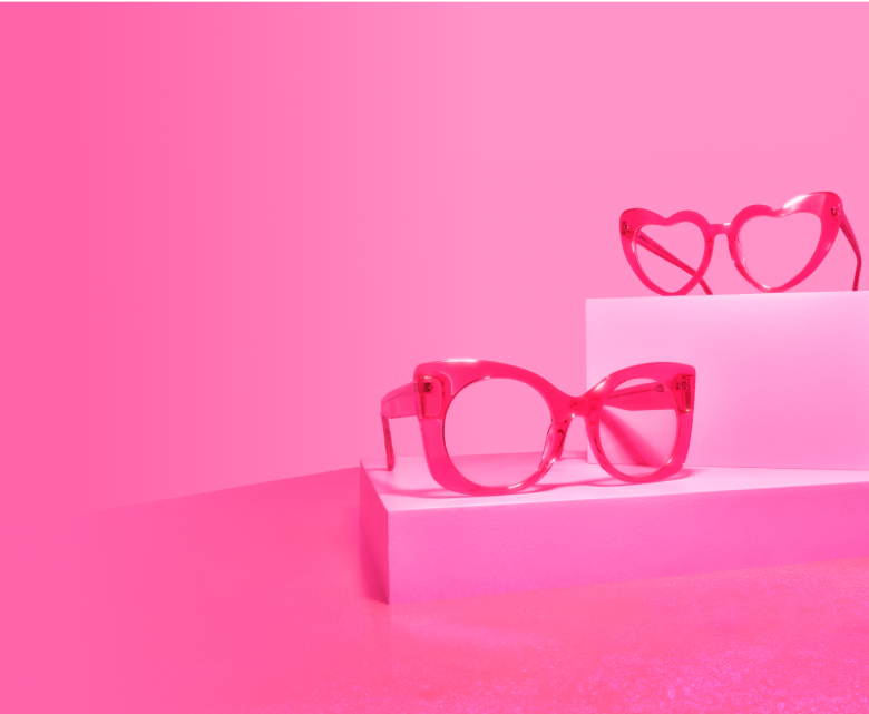 Image of 2 pairs of Zenni glasses. From top to bottom are heart-shape translucent pink, and cat-eye translucent pink frame.