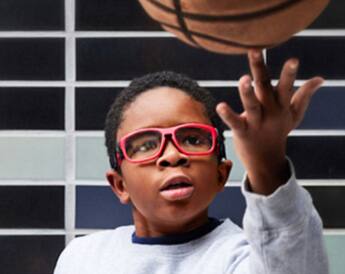 Image of a kid playing basketball, wearing Zenni kids' sport protective goggles #743318.