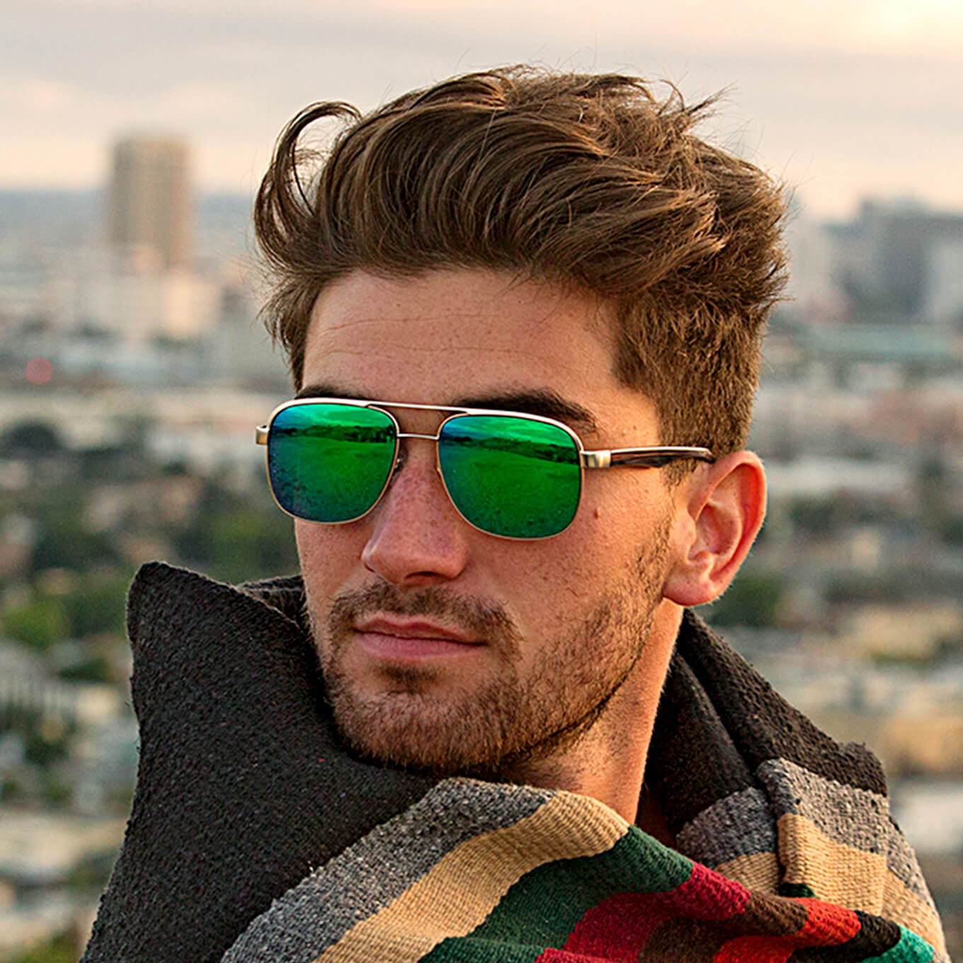 Sunset aviator sunglasses in brushed gold metal with green mirror tint lenses.