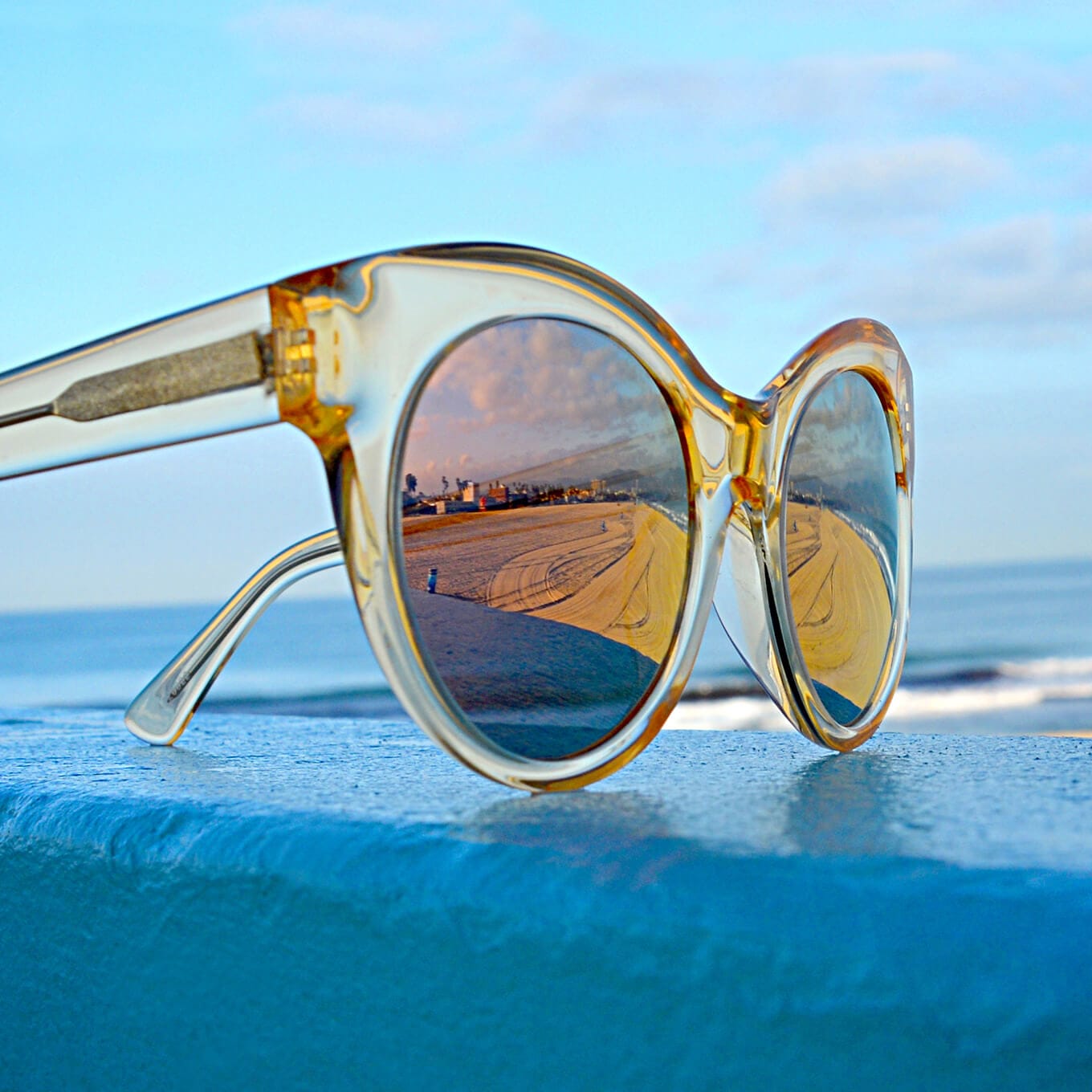 Venice cat-eye acetate sunglasses in translucent yellow with silver mirror tint.