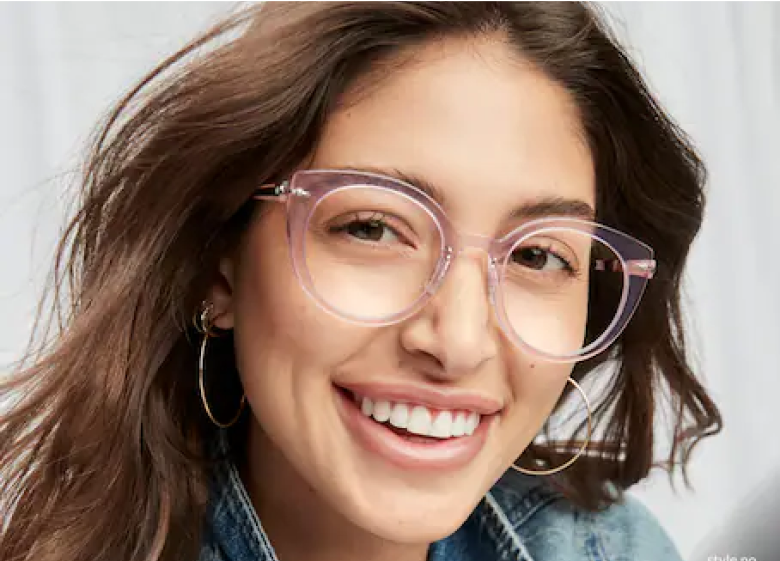 Image of a woman smiling, wearing Zenni cat-eye glasses #7828219 in front of a white background.
