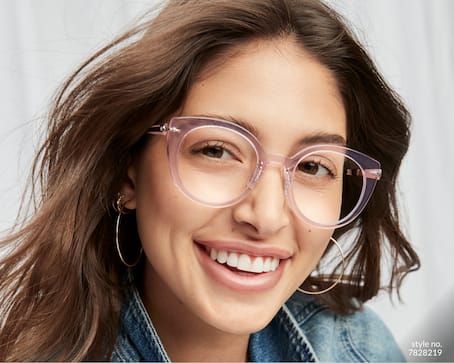 Image of a woman smiling, wearing Zenni cat-eye glasses #7828219 in front of a white background.